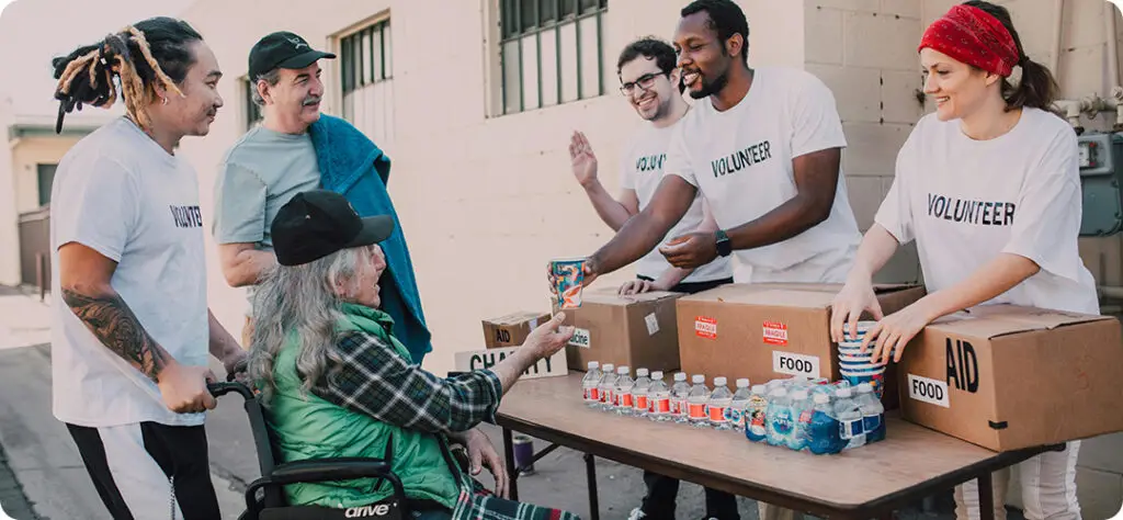 Volunteers handing out donations to illustrate the impact of charitable contributions